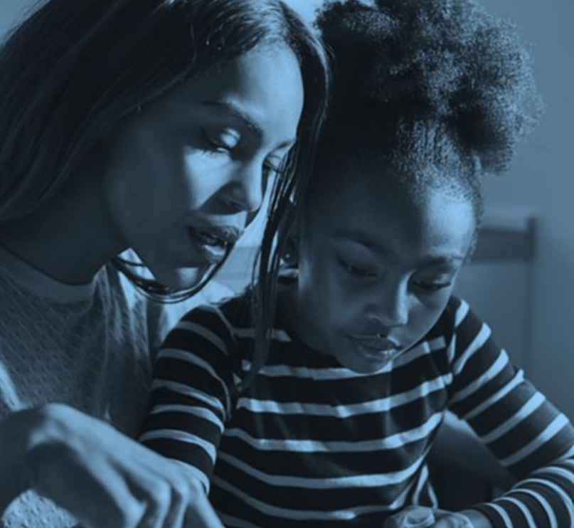A parent helping a child with schoolwork